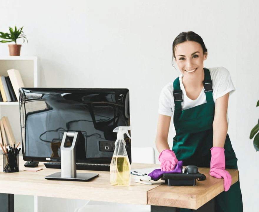 Cleaning specialist wiping down a workstation